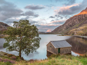 Last light at Llyn Ogwen - As the sun sets, a soft warm light falls across the landscape at Llyn Ogwen in Snowdonia, North Wales. Highlighting the top of Tryfan and the clouds beyond