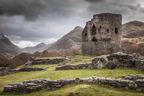 A Castle in the Mountains - Dolbadarn Castle stands below some stormy looking clouds on the hillside above llyn padarn in llanberis, Snowdonia National Park