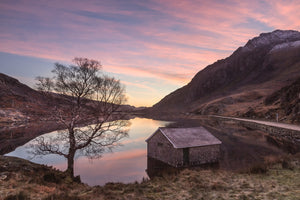 Winter sunrise at Llyn Ogwen, Snowdonia - North Wales. Vibrant Colours fill the sky over Tryfan and Ogwen Valley, reflecting in the still waters of the lake below. Smart Imaging & Framing Landscape Photography