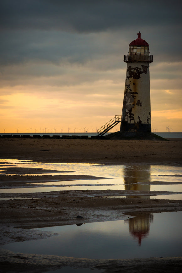 Point of Ayr lighthouse, with it's characteristic 'lean', is almost silhouetted against the stormy skies behind. The sunset on this evening only produced a small amount of colour but it was just enough to break up the predominently blue/grey tones in this image.